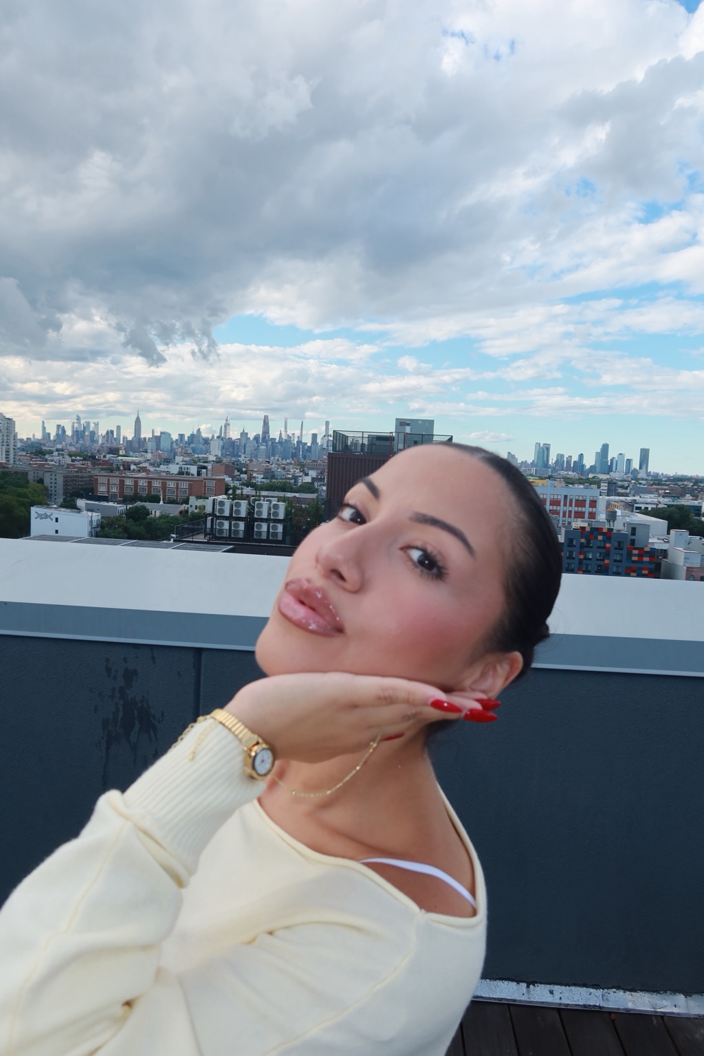Jessica on a rooftop overlooking the New York City skyline